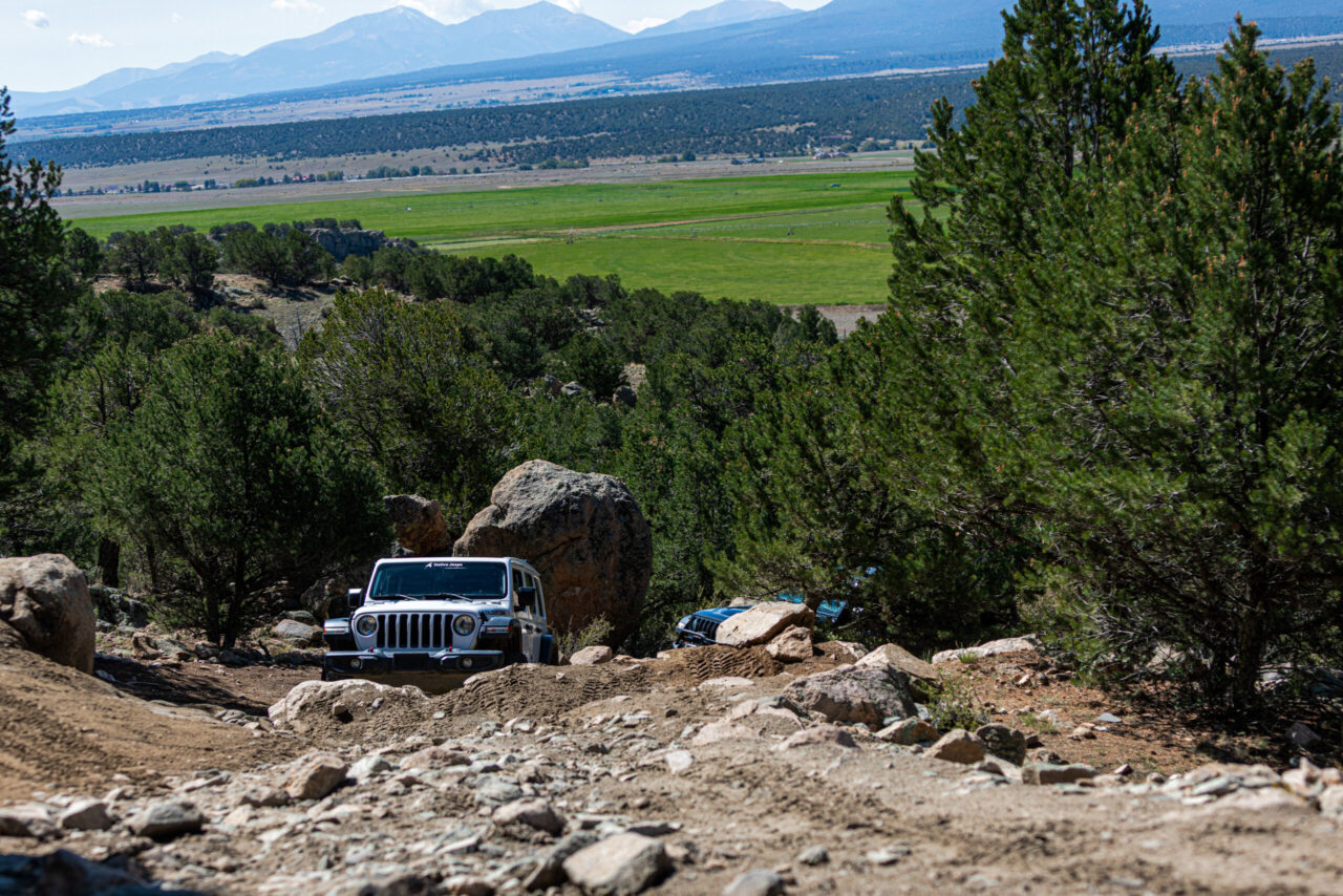  White Jeep on scenic overlook with valley and mountains in background, Yansing Gulch near Denver