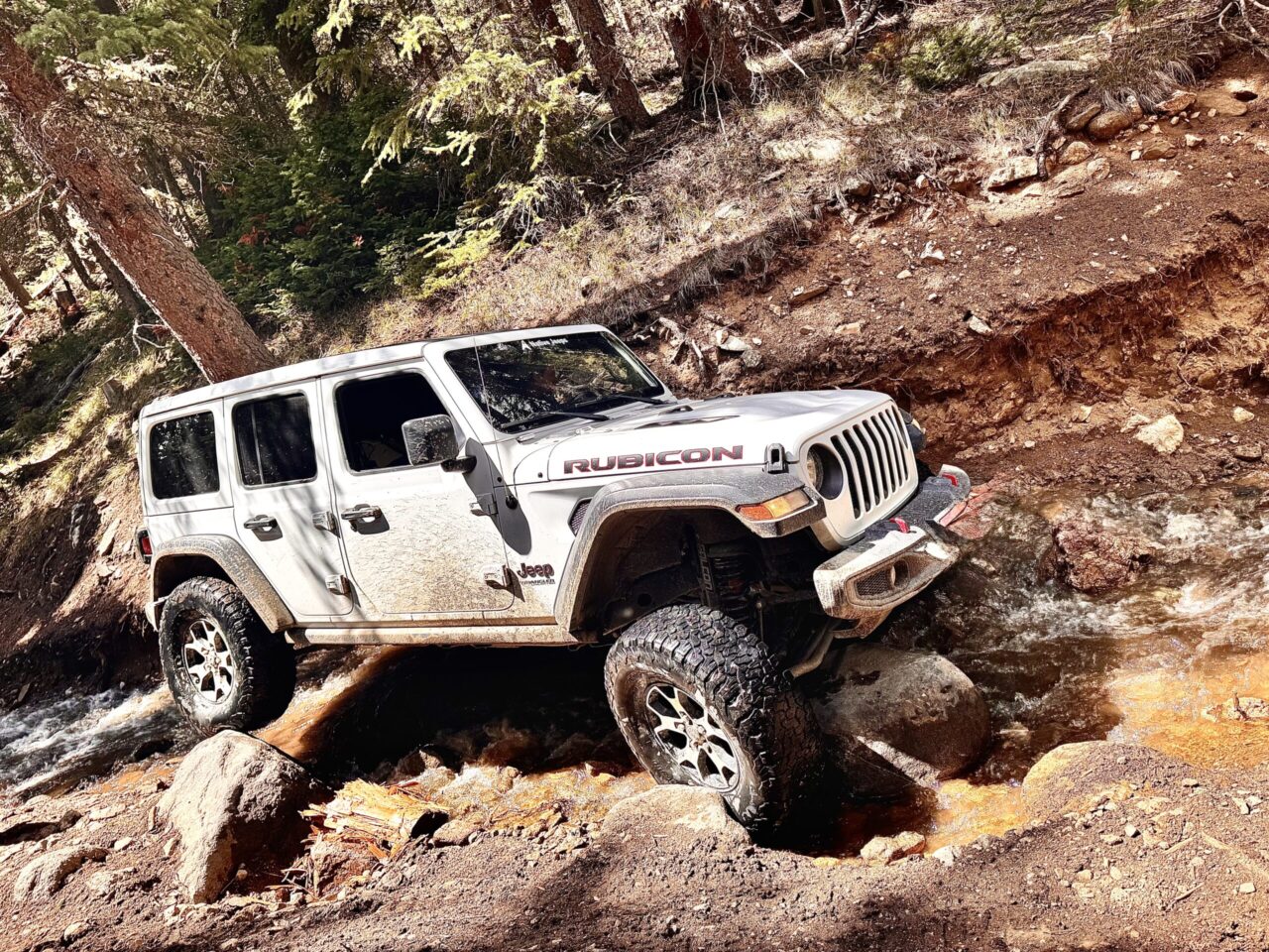 Native Jeeps modified Jeep climbing rocky obstacle off-road